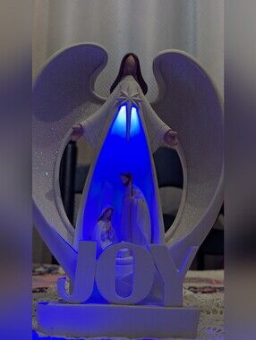 Angel and nativity figurine is an elegant Christmas decoration Blue LED light